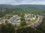 Thumbnail 11 of 32 - A bird's eye view of a residential area with houses and trees.