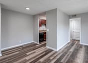 Thumbnail 18 of 25 - A room with wooden flooring and white walls.