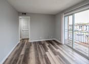 Thumbnail 11 of 25 - A room with a sliding glass door leading to a balcony.