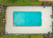 Thumbnail 8 of 25 - An above ground pool surrounded by a fence.