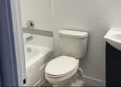 Thumbnail 7 of 7 - a white toilet sitting next to a bath tub