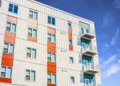 Thumbnail 66 of 74 - a tall building with balconies and a blue sky