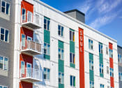 Thumbnail 65 of 74 - the facade of a hotel with colorful doors and balconies