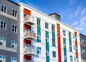 Thumbnail 57 of 74 - a colorful apartment building with a blue sky in the background