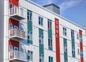 Thumbnail 53 of 74 - a building with a red and white facade and a blue sky