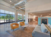 Thumbnail 39 of 74 - a living room with couches and chairs under a colorful ceiling