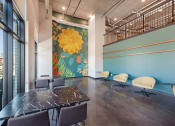 Thumbnail 43 of 74 - a conference room with a table and chairs and a mural on the wall
