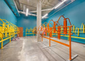 Thumbnail 38 of 74 - a playground area in a building with blue walls and yellow equipment