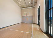 Thumbnail 50 of 74 - a basketball court in a large room with wood floors