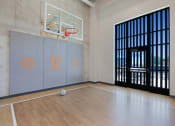 Thumbnail 49 of 74 - a basketball court in a large room with a door to a gym with a basketball