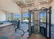 Thumbnail 52 of 74 - a gym with weights and other exercise equipment in a room with windows
