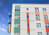 Thumbnail 68 of 74 - a tall building with a sign on the side of it