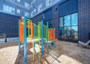 Thumbnail 28 of 74 - a colorful playground in a courtyard of a building