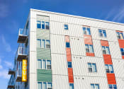 Thumbnail 63 of 74 - a tall building with a sign on the side of it