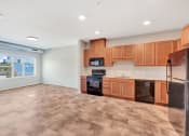 Thumbnail 7 of 74 - an empty kitchen with wooden cabinets and stainless steel appliances