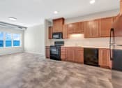 Thumbnail 8 of 74 - an empty kitchen with wood cabinets and stainless steel appliances