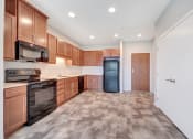 Thumbnail 10 of 74 - a kitchen with wooden cabinets and a stainless steel refrigerator
