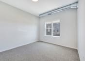 Thumbnail 19 of 74 - an empty room with a window and white walls