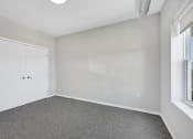 Thumbnail 18 of 74 - an empty bedroom with white walls and a closet