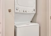 Thumbnail 15 of 74 - a small laundry room with a washer and dryer in the door