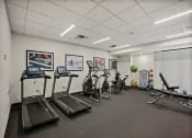 Thumbnail 34 of 61 - a gym with treadmills and other exercise equipment