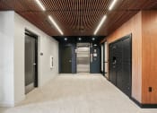 Thumbnail 31 of 61 - a hallway with black doors and white walls