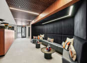 Thumbnail 32 of 61 - a lobby with couches and tables