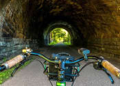 Thumbnail 47 of 61 - a bike is parked in front of a tunnel