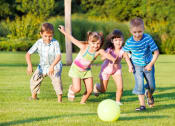 Thumbnail 60 of 61 - a group of children playing with a ball on the grass