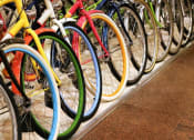 Thumbnail 54 of 61 - a row of colorful bikes on a rack