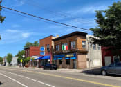 Thumbnail 48 of 61 - a city street with cars parked on the side of the road