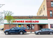 Thumbnail 45 of 61 - a store with a blue truck parked in front of it