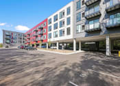 Thumbnail 29 of 61 - a building with a parking lot in front of it