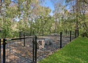 Thumbnail 38 of 61 - a fenced in area with trees in the background