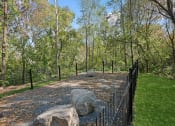 Thumbnail 39 of 61 - a fenced in area with rocks and trees in the background