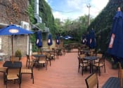 Thumbnail 57 of 61 - a wooden deck with many tables and umbrellas