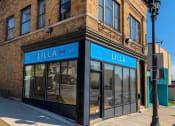 Thumbnail 42 of 61 - a building with a blue sign on the front of it