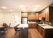Thumbnail 15 of 21 - A kitchen with brown cabinets and a white counter.