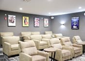Thumbnail 4 of 21 - A row of beige recliner chairs are lined up in a room.