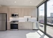 Thumbnail 8 of 24 - a kitchen with a refrigerator freezer and a stove top oven at Platform 4611, Chicago, IL