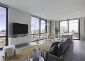 Thumbnail 2 of 24 - a living room with a gray couch and a yellow rug at Platform 4611, Chicago