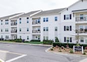 Thumbnail 21 of 28 - Apartment complex with a sign that says "Avalon".