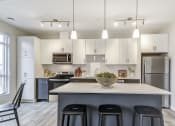 Thumbnail 16 of 28 - Kitchen with white cabinets and a large island at 101 Base Line Road West, London