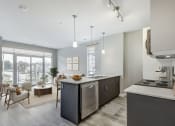 Thumbnail 21 of 28 - Kitchen with an island and a living room with a window  at 101 Base Line Road West, London, Ontario