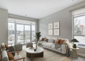 Thumbnail 20 of 28 - Living room with a white couch and a large window  at 101 Base Line Road West, London, ON