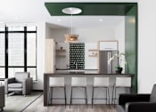 Thumbnail 7 of 28 - A modern kitchen with white and black furniture and a green accent wall.