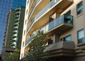 Thumbnail 2 of 21 - an apartment building with a tree in front of it