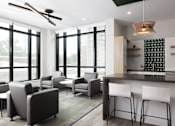 Thumbnail 6 of 28 - A modern living room with grey and white furniture.