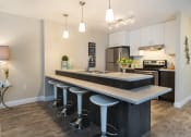 Thumbnail 14 of 19 - a kitchen with an island and stools