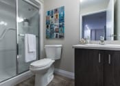 Thumbnail 18 of 19 - a bathroom with a toilet sink and shower